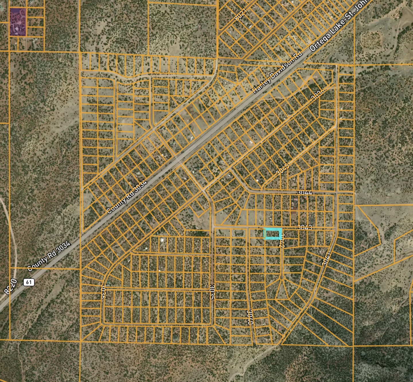 Top-down satellite parcel map with the County Road 3043 lot outlined in cyan